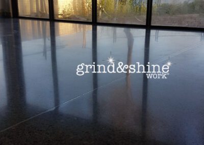Concrete grinding showing reflection of glass and view in floor